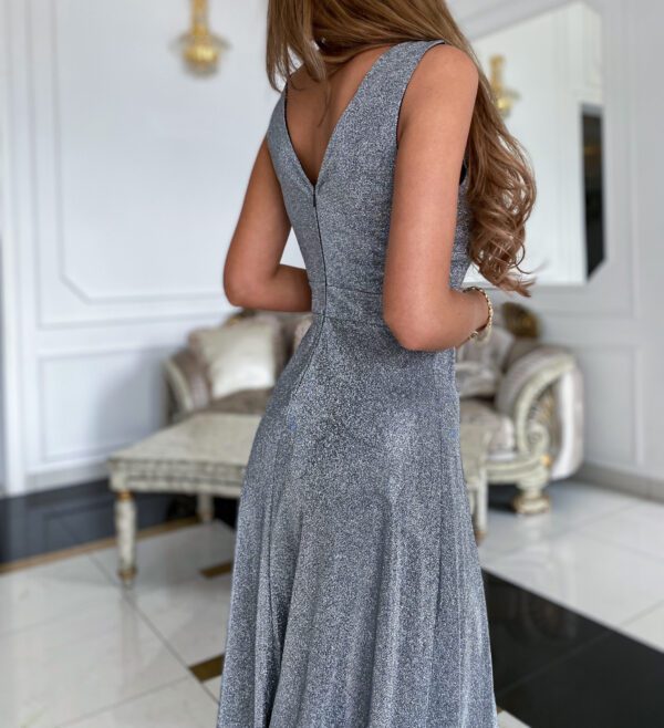 Back view of the Luiza Silver Glitter Maxi Dress featuring a v-shaped back and a flowing silhouette for a glamorous evening look.