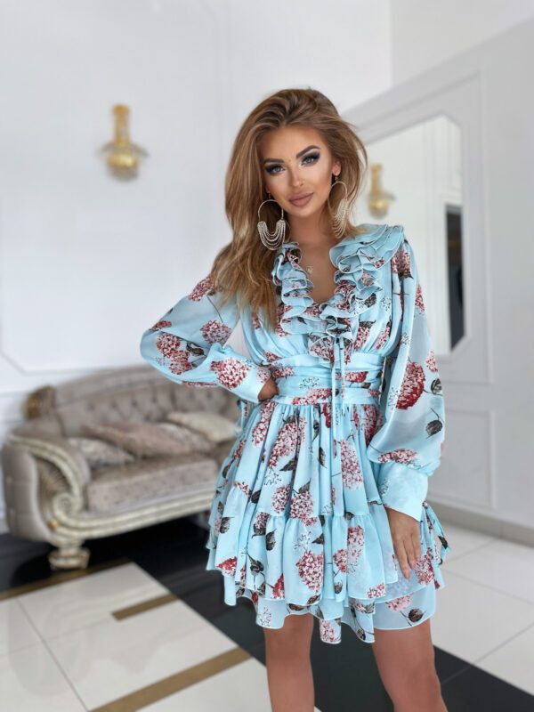 Front view of the Sophia Mint Blue Floral Mini Day Dress, emphasizing its flattering silhouette, intricate floral design, and elegant ruffled accents worn by a model in a sophisticated environment.