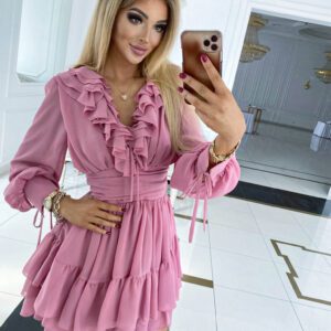 Close-up of a model wearing a Sophia Dust Pink Mini Party Dress, showcasing the elegant ruffled neckline and cinched waist, ideal for going out.